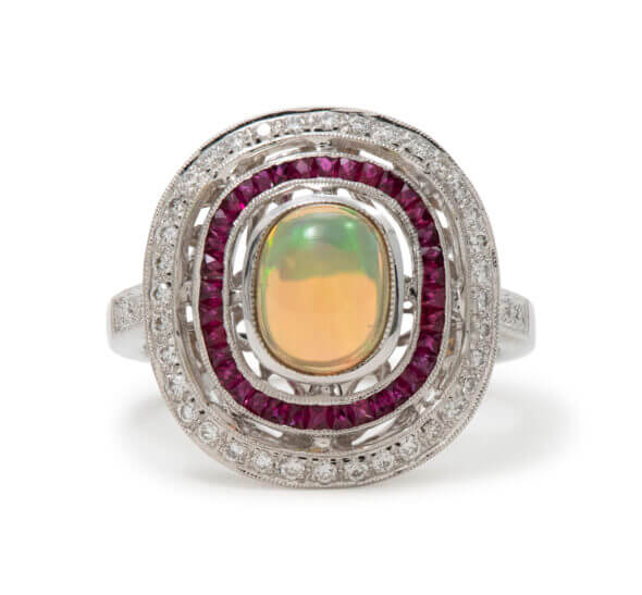 18 Karat White Gold Opal, Ruby and Diamond Halo Ring front view
