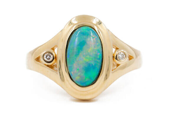 14 Karat yellow gold bezel set Opal Ring with diamond accents front view
