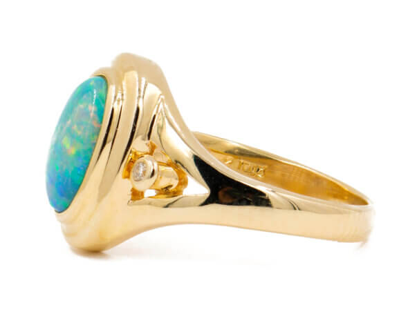 14 Karat yellow gold bezel set Opal Ring with diamond accents side view