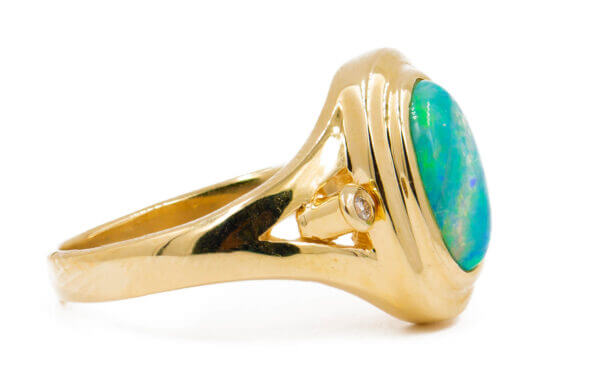 14 Karat yellow gold bezel set Opal Ring with diamond accents side view