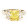 1.87 Carat Fancy Intense Yellow Diamond Ring with 2 Radiant Cut Accent Diamonds in Platinum | 18 Karat Yellow Gold front view