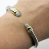 Silver and 18 Karat Yellow Gold Basket Weave Bracelet With Pavé Diamond End Caps on wrist