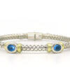 Silver and 18 Karat Yellow Gold Weave Bracelet with Bezel Set Topaz front view