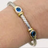 Silver and 18 Karat Yellow Gold Weave Bracelet with Bezel Set Topaz on a view