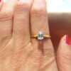18 Karat Yellow Gold and Platinum Emerald Cut Diamond Solitaire Ring on finger