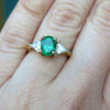 14 Karat Yellow and White Gold Emerald and Trillion Cut Diamond Ring on finger