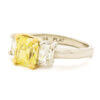 1.87 Carat Fancy Intense Yellow Diamond Ring with 2 Radiant Cut Accent Diamonds in Platinum | 18 Karat Yellow Gold left side