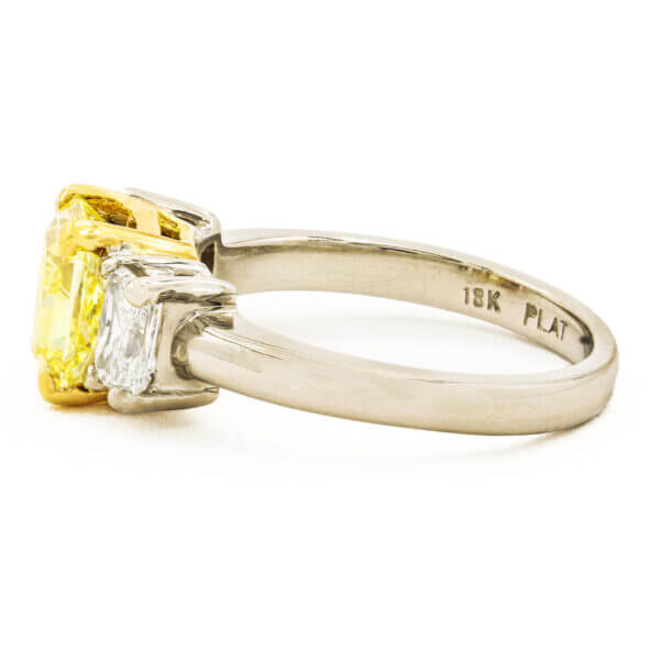 1.87 Carat Fancy Intense Yellow Diamond Ring with 2 Radiant Cut Accent Diamonds in Platinum | 18 Karat Yellow Gold side